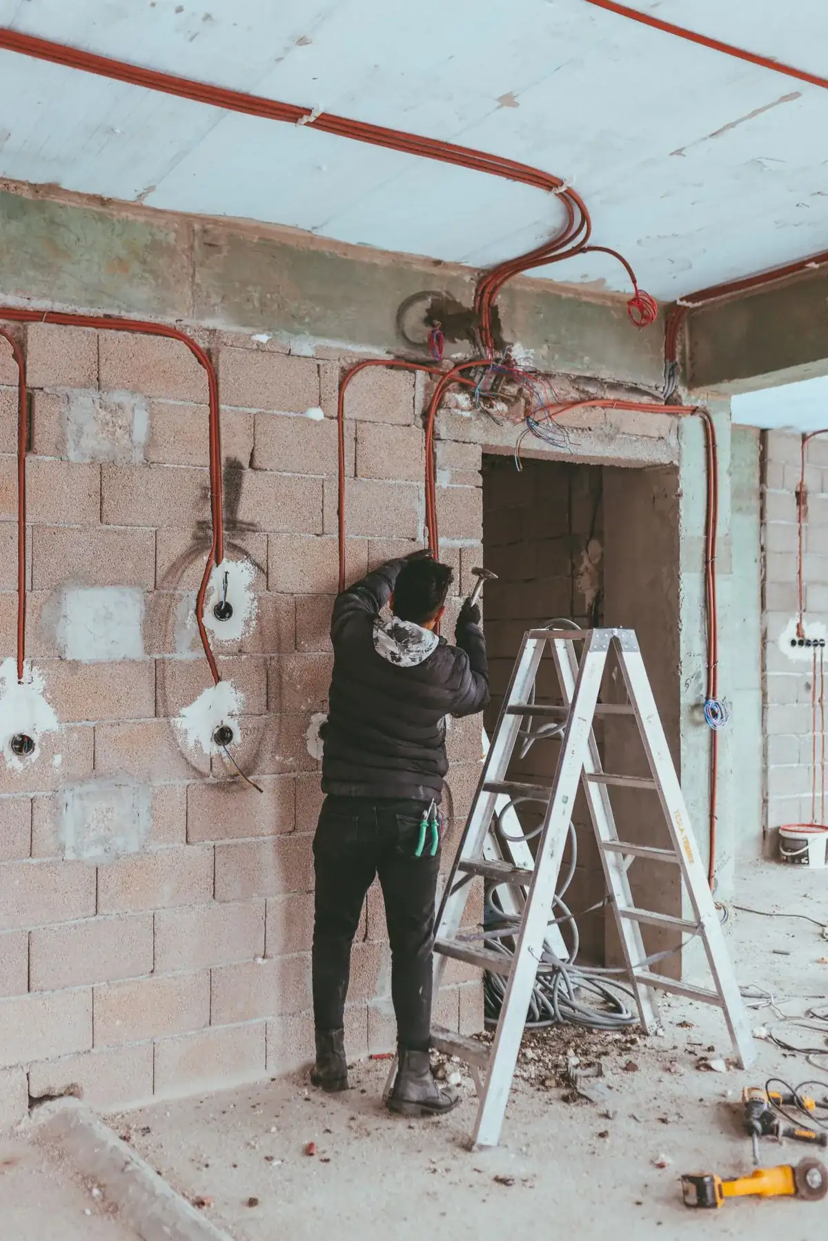 Electrician running wiring on a job site